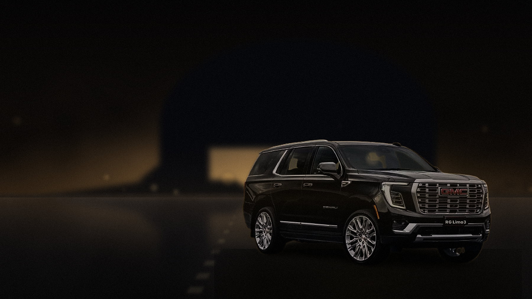 Black GMC Yukon Denali beside a lit private hangar at Van Nuys Airport in the evening