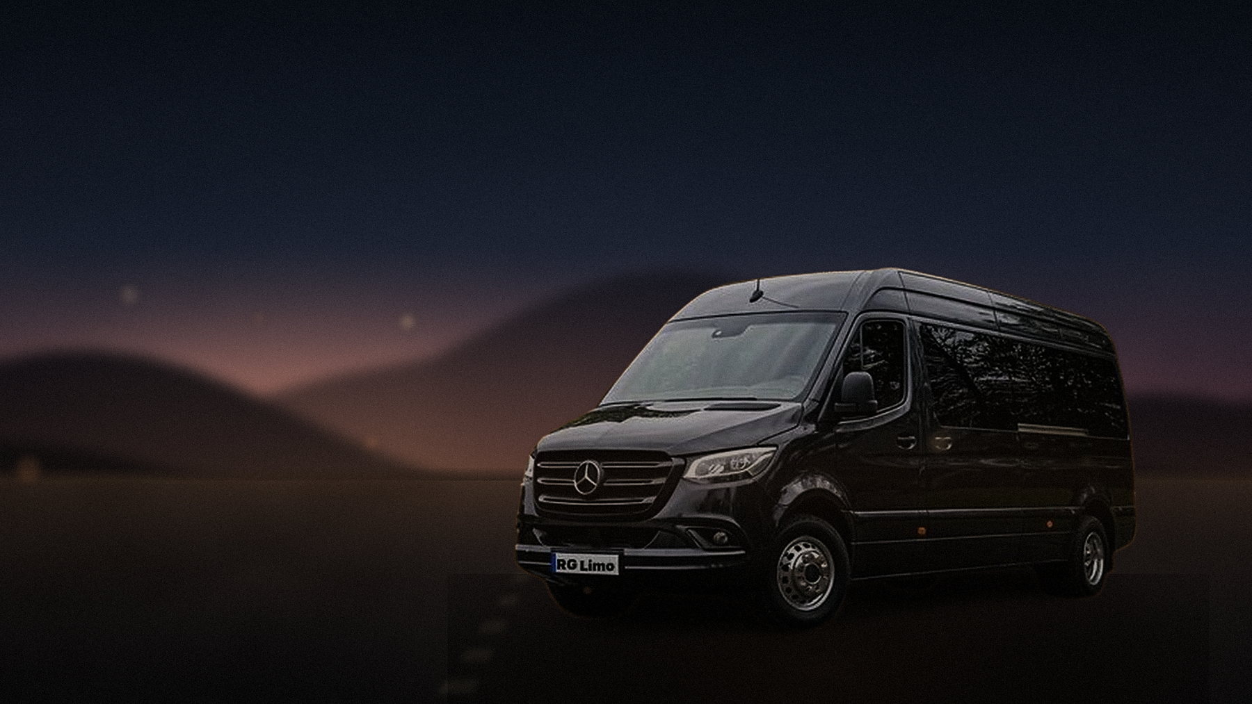 Black Mercedes-Benz Sprinter van crossing the Coachella Valley at dusk with the desert ridgeline behind it