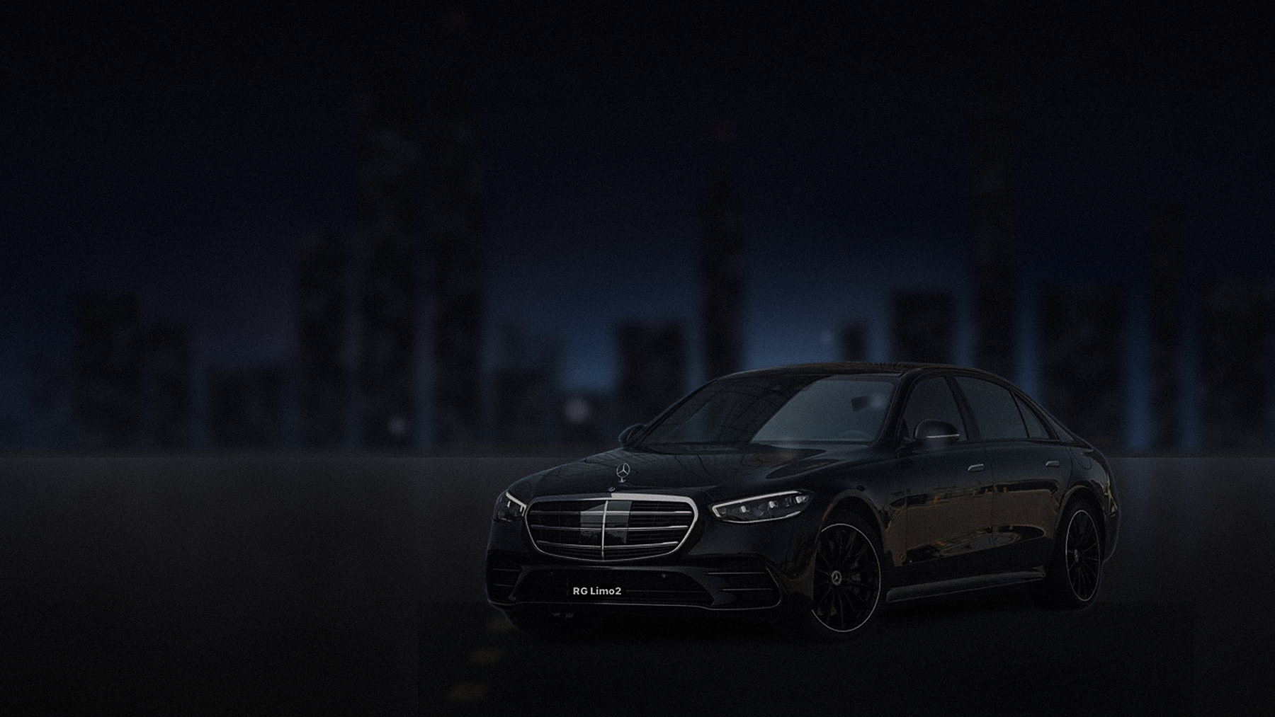 Black Mercedes-Benz S-Class sedan photographed against the downtown Los Angeles skyline at night