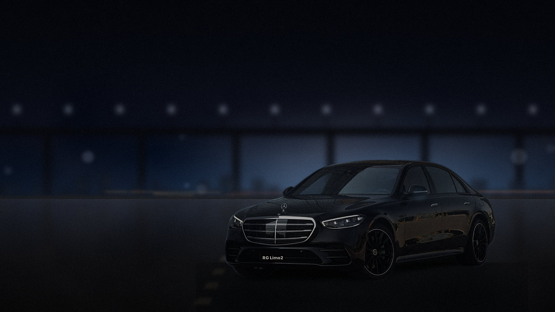 Black Mercedes-Benz S-Class sedan on a Los Angeles freeway at night with the skyline in the distance
