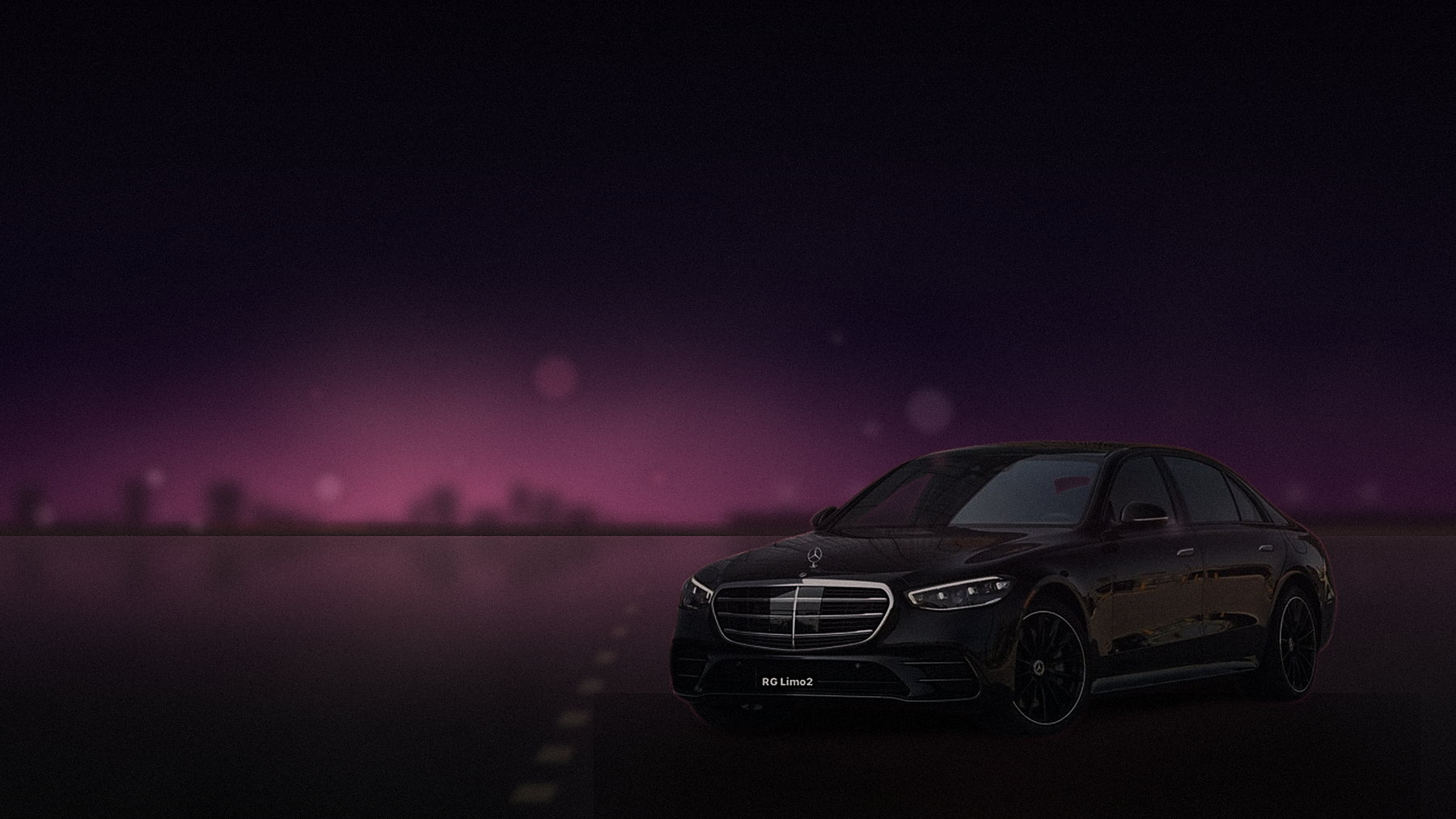 Black Mercedes-Benz S-Class sedan near Santa Monica Pier at night with the lights on the water