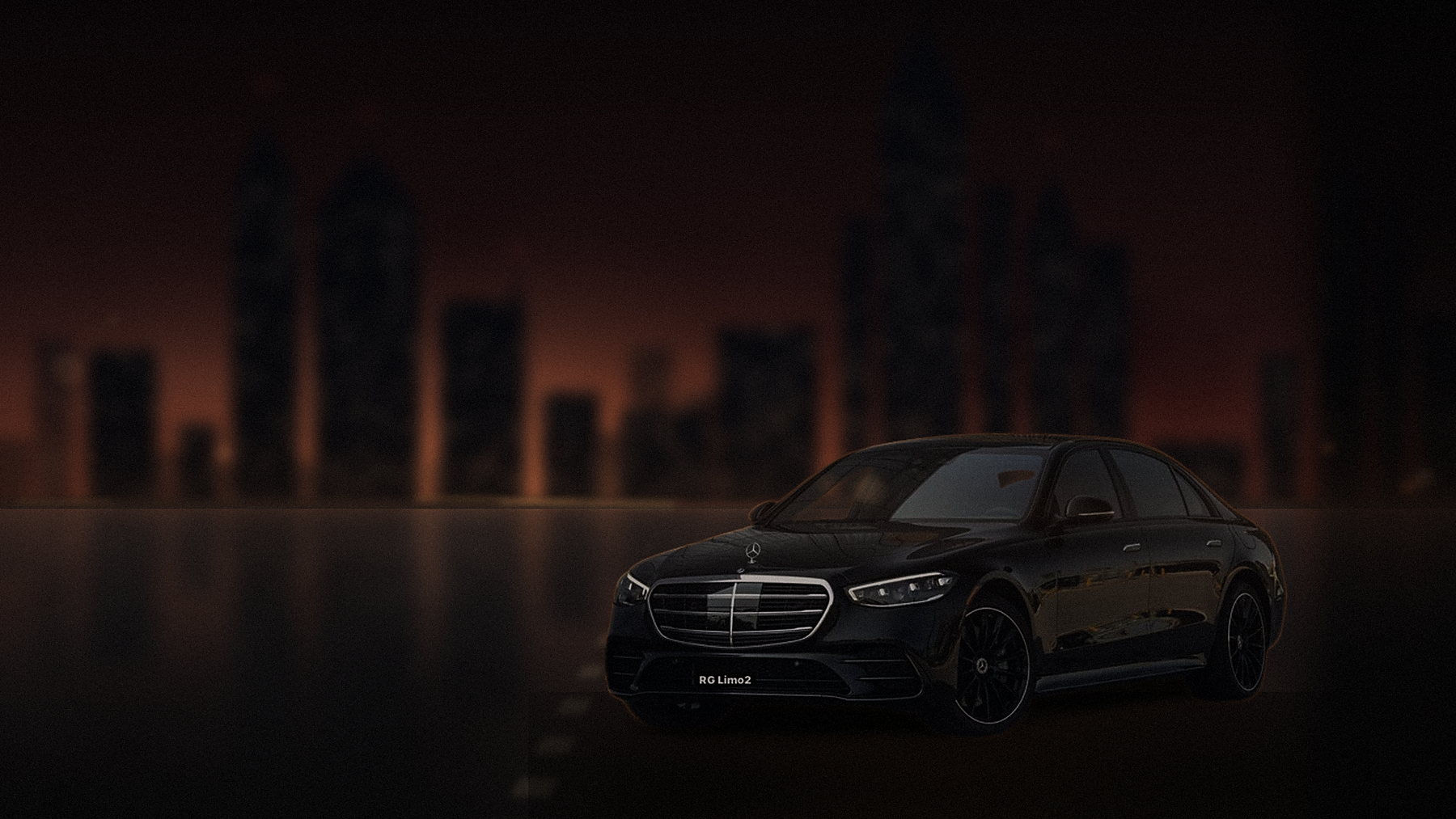 Black Mercedes-Benz S-Class sedan on a downtown Los Angeles street at dusk with the towers behind it
