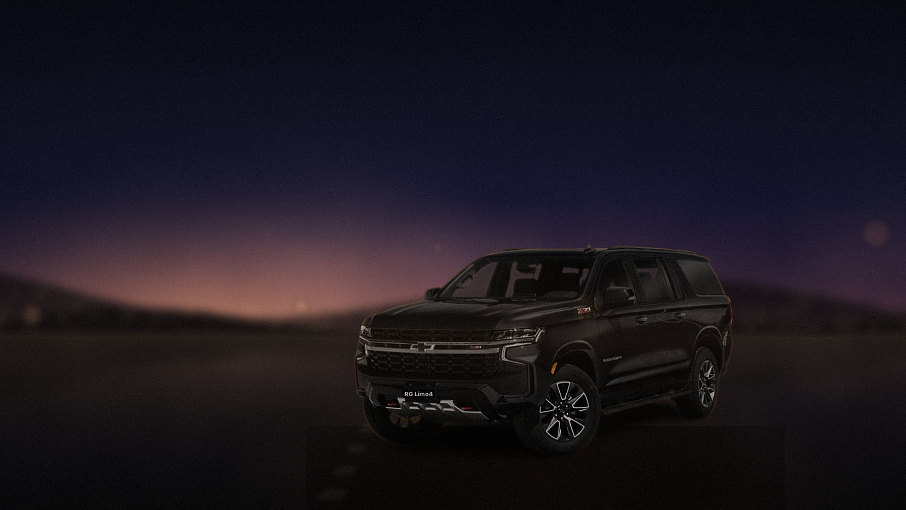 Black Chevrolet Suburban on a canyon road above Los Angeles at dusk